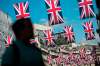 SIMON DAWSON / BLOOMBERG 
A pedestrian walks underneath rows British Union flags suspended above Regent Street in London, U.K., on Tuesday, May 24, 2016.