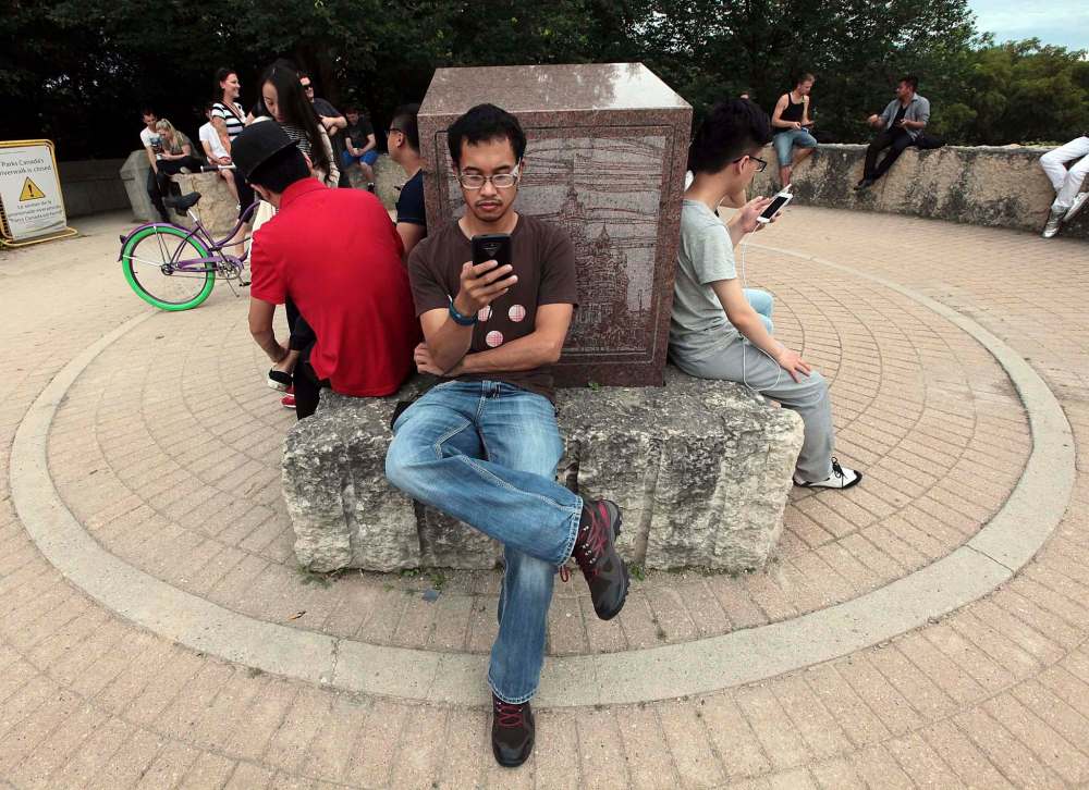 PHIL HOSSACK / WINNIPEG FREE PRESS
Mark Petrasanta followed his phone to a Pokemon meet-up at the Oodena Celebration Circle at The Forks.