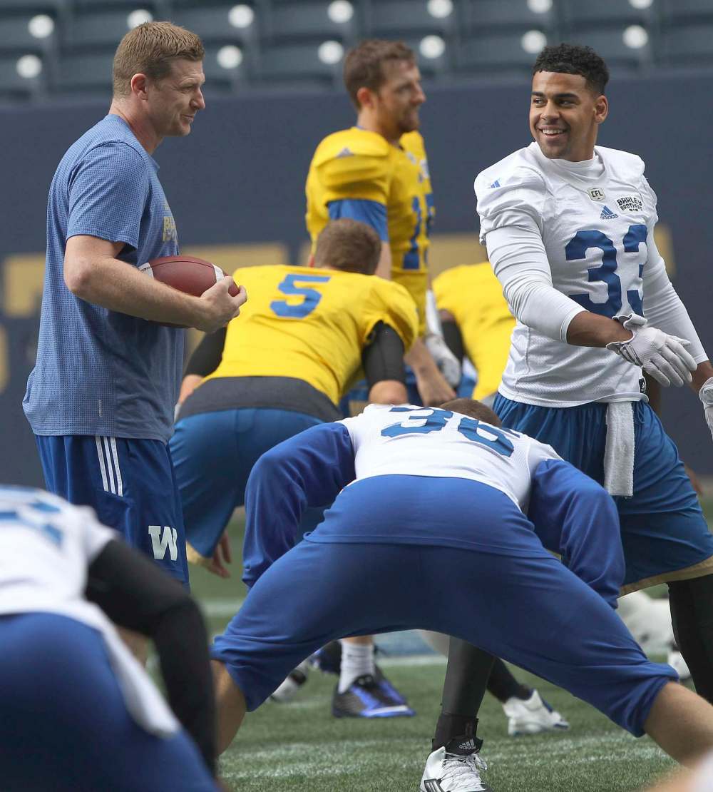 JOE BRYKSA / WINNIPEG FREE PRESS
Winnipeg Blue Bombers head coach Mike O'Shea (left) has a laugh with Bombers Andrew Harris at practice Monday at Investors Group Field.