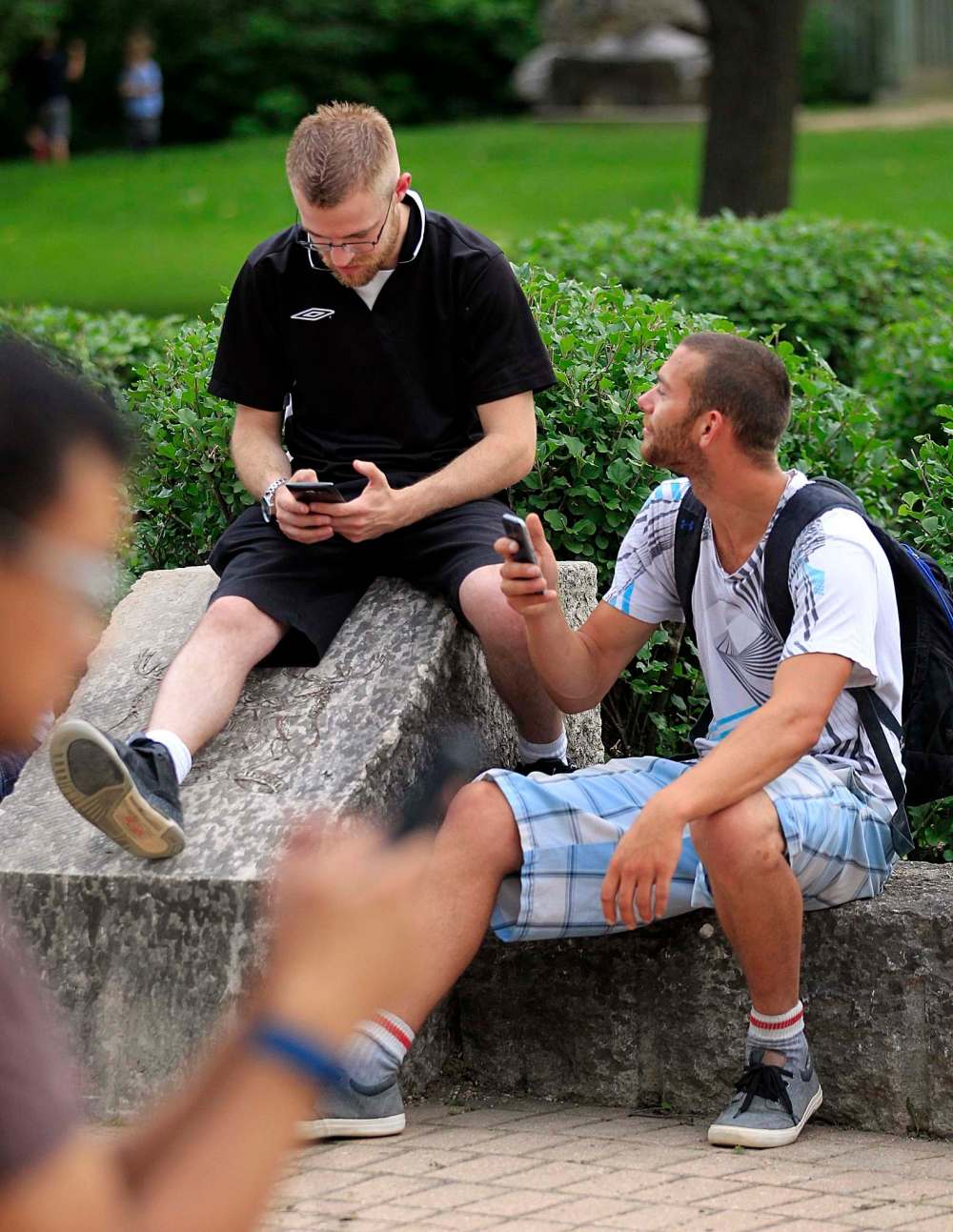 PHIL HOSSACK / WINNIPEG FREE PRESS
27-year-old Justin Enns (left) and Jesse Claeys, 24 followed their phone to a Pokemon meet-up at the Oneda Circle.