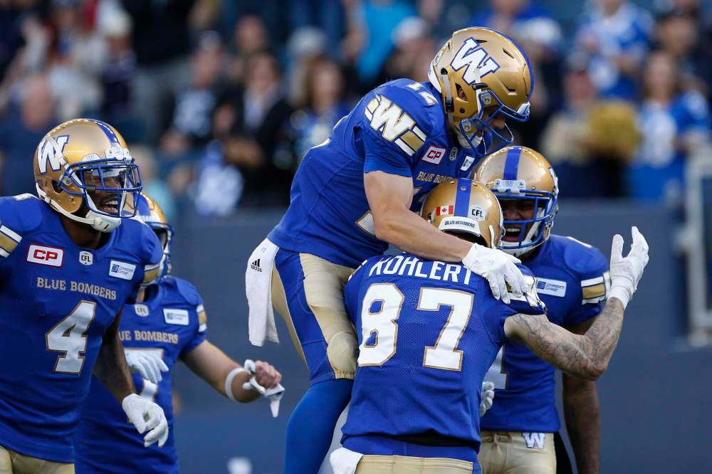 JOHN WOODS / THE CANADIAN PRESS
Winnipeg Blue Bombers' Ryan Smith (12), Rory Kohlert (87) and Jace Davis (1) celebrate Kohlert's touchdown against the Edmonton Eskimos during the first half of Thursday's game at Investors Group Field.