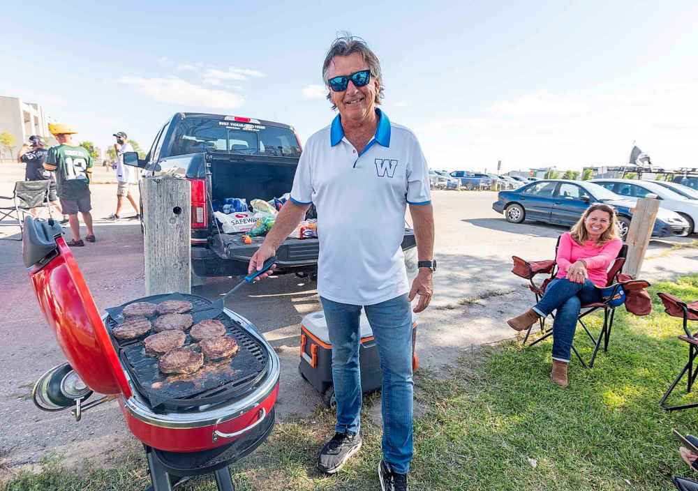 SASHA SEFTER / WINNIPEG FREE PRESS
Tailgater David Olivier grilles up some burgers in a parking lot for his family before the NFL pre-season game between the Green Bay Packers and Oakland Raiders at IG Field Thursday evening.