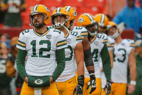 CPFILE - In this Sept. 23, 2018, file photo, Green Bay Packers quarterback Aaron Rodgers (12) warms up with the team before the NFL football game against the Washington Redskins in Landover, Md. A prime-time showdown between two of the league's most successful quarterbacks highlights Week 9 of the NFL season. Aaron Rodgers and the Packers head to New England to take on Tom Brady and the Patriots. (AP Photo/Carolyn Kaster, File)