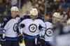LIAM RICHARDS / THE CANADIAN PRESS
Paul Postma (left) and Toby Enstrom (right) help Dustin Byfuglien back to the bench Friday.