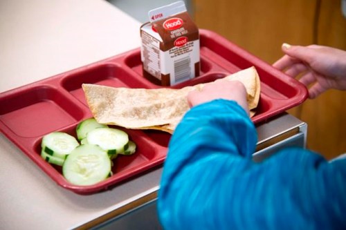 FILE - In this undated file photo, a student eats lunch at William Allen School in Rochester, N.H. Oregon has approved the largest statewide expansion of the federal free lunch program, ensuring all students living up to three times above the poverty line will have access to free meals. It's the first time a state has offered to completely take on school meal costs, which can often run tens of thousands of dollars for individual school districts. The move is expected to provide hundreds of thousands of students with free breakfast and lunch. (John Huff/Portsmouth Herald via AP, File)