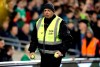 A member of security collects tennis balls as they are thrown on to the pitch by fans to interrupt game time in protest of Chief Executive of the Football Association of Ireland John Delaney during the UEFA Euro 2020 Qualifying, Group D match at the Aviva Stadium, Dublin, Tuesday March 26, 2019.(Niall Carson/PA via AP)
