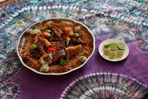 In this Nov. 24, 2018, photo, a platter of thiebou dieune, a traditional Senegalese dish of spiced rice, is serve by Chef Touty Sarr, in Ngaparou, Senegal. In the quiet hours before lunch, two women worked side by side in an airy kitchen. One, a chef, cleaned fresh red snapper filets with a sharp knife. The other, a filmmaker, pointed her camera into a large pot of simmering vegetables. (AP Photo/Amelia Nierenberg)