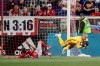 Montreal Impact goalkeeper Evan Bush, right, dives after collecting the ball, next to New York Red Bulls forward Tom Barlow during the first half of an MLS soccer match Wednesday, May 8, 2019, in Harrison, N.J. (AP Photo/Julio Cortez)