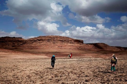 ADVANCE FOR PUBLICATION ON WEDNESDAY, APR. 10, AND THEREAFTER - In this March 30, 2019 photo, Umm Yasser, center, leads women on a trek in the mountains, near Wadi Sahw, Abu Zenima, in South Sinai, Egypt. Umm Yasser is breaking new ground among the deeply conservative Bedouin of Egypt‚Äôs Sinai Peninsula. Women among the Bedouin almost never work outside the home, and even more rarely do they interact with outsiders. But Umm Yasser is one of four women from the community who for the first time are working as tour guides. (AP Photo/Nariman El-Mofty)