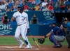 Toronto Blue Jays third baseman Vladimir Guerrero Jr., left, reacts in pain after taking a foul ball off his foot as Texas Rangers catcher Jeff Mathis, centre, looks on during first inning American League MLB baseball action in Toronto on Tuesday, August 13, 2019. THE CANADIAN PRESS/Nathan Denette