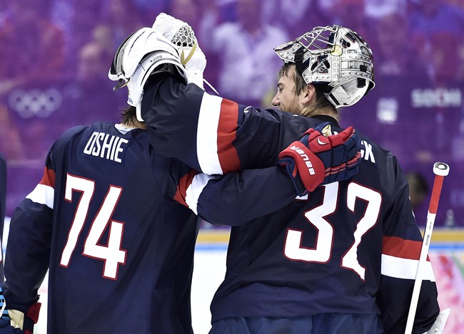 United States forward T.J. Oshie (74) congratulates United States goalie Jonathan Quick (37) after defeating Russia in a shoot-out during preliminary hockey action at the 2014 Sochi Winter Olympics in Sochi, Russia on Saturday, February 15, 2014. THE CANADIAN PRESS/Nathan Denette