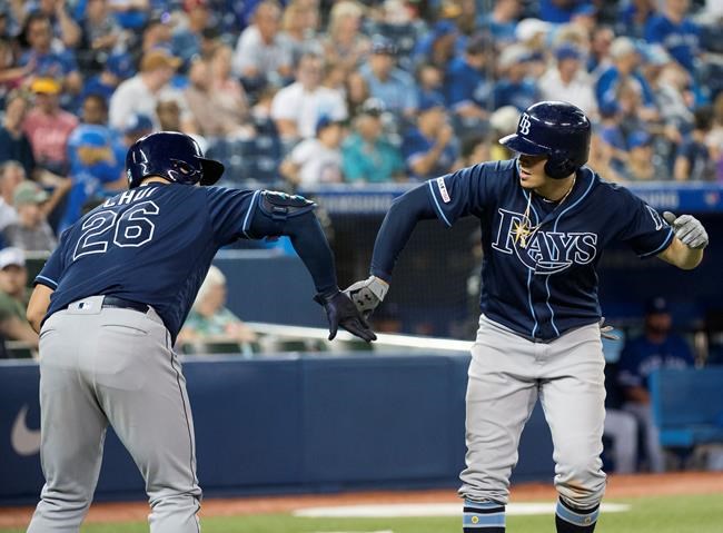 Tampa Bay Rays shortstop Willy Adames (1) celebrates a two run home run with teammate Ji-Man Choi (26) during eighth inning American League MLB baseball action against the Toronto Blue Jays, in Toronto on Sunday, July 28, 2019. THE CANADIAN PRESS/Nathan Denette