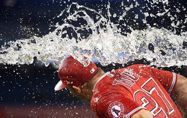 Los Angeles Angels centre fielder Mike Trout (27) doused in Gatorade by teammates after defeating the Toronto Blue Jays in MLB American League baseball action in Toronto on Wednesday June 19, 2019. Trout hit a pair of home runs including the sixth grand slam of his career and seven RBIs. THE CANADIAN PRESS/Nathan Denette