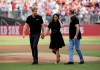 Britain's Prince Harry, left, and Meghan, Duchess of Sussex, walk off the field before a baseball game between the Boston Red Sox and the New York Yankees, Saturday, June 29, 2019, in London. Major League Baseball makes its European debut game today at London Stadium. (AP Photo/Tim Ireland)