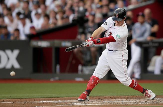 Boston Red Sox's Brock Holt hits an RBI single against the New York Yankees during the first inning of a baseball game, Saturday, June 29, 2019, in London. Major League Baseball made its European debut game today at London Stadium. (AP Photo/Tim Ireland)