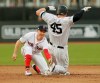 New York Yankees' Luke Voit slides safely into second base beside Boston Red Sox's Brock Holt after hitting a double during the fifth inning of a baseball game, Saturday, June 29, 2019, in London. Major League Baseball made its European debut game Saturday at London Stadium. (AP Photo/Tim Ireland)