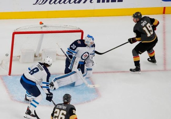 Vegas Golden Knights right wing Reilly Smith (19) scores against Winnipeg Jets goaltender Laurent Brossoit during the first period of an NHL hockey game Thursday, March 21, 2019, in Las Vegas. (AP Photo/John Locher)