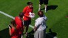 A representative from the World Cup’s local organizing committee presents Canada captain Christine Sinclair with flowers on her 36th birthday during a practice session at Stade Paul Bourgeat in Grieres, France, just outside of Grenoble on Wednesday, June 12, 2019. THE CANADIAN PRESS/Neil Davidson