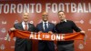 Toronto FC president Bill Manning (left to right), new general manager Ali Curtis and head coach Greg Vanney hold up a team scarf at a news conference introducing Curtis in Toronto, Thursday, Jan.3, 2019. THE CANADIAN PRESS/Neil Davidson