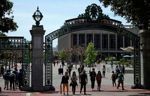 FILE - In this May 10, 2018, file photo, students walk past Sather Gate on the University of California at Berkeley campus in Berkeley, Calif. Choosing a college based on price can save you from overwhelming student debt, give your parents a break and increase the likelihood of a return on investment in your education. (AP Photo/Ben Margot, file)