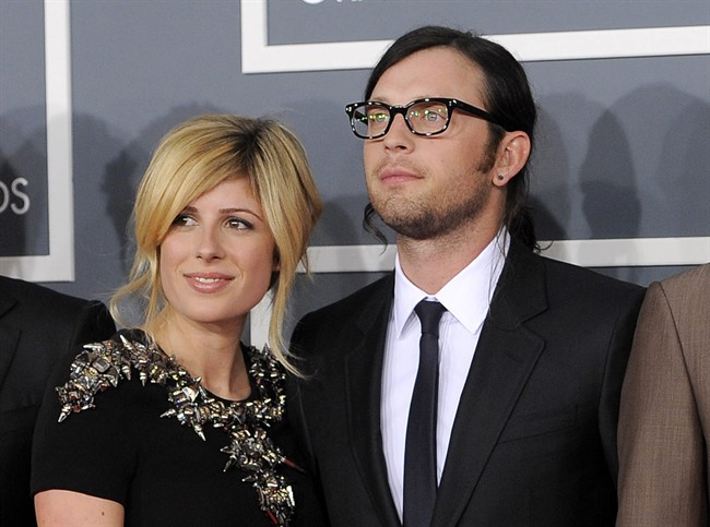 FILE - This Feb. 12, 2012 file photo shows Jessie Baylin with her husband Nathan Followill of the band Kings of Leon at the 54th annual Grammy Awards in Los Angeles. Followill and Baylin welcomed a baby girl on Wednesday, Dec. 26, 2012. (AP Photo/Chris Pizzello, File)