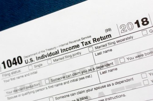 FILE - This July 24, 2018, file photo shows a portion of the 1040 U.S. Individual Income Tax Return form for 2018 in New York. If you‚Äôve lost or never received your W-2, old tax returns, 1099s or 1098s to complete your tax return, there are a few things you can do to get back on track and give yourself more time. (AP Photo/Mark Lennihan, File)