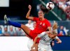 FILE - In this May 16, 2019, file photo, United States' Alex Morgan (13) and New Zealand's Katie Duncan (16) vie for the ball during the first half of an international friendly soccer match in St. Louis. The Women’s World Cup kicks off Friday, June 7, 2019, in Paris. Morgan was named the U.S. national team’s Player of the Year after she closed out 2018 with 18 goals in 19 games. She had seven goals during the CONCACAF World Cup qualifying tournament alone. (AP Photo/Jeff Roberson, File)