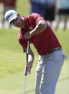 FILE - In this May 9, 2013 file photo, Adam Scott of Australia putts on the 15th green during the first round of The Players championship golf tournament at TPC Sawgrass in Ponte Vedra Beach, Fla. Golf's governing bodies have adopted a new rule that outlaws the putting stroke used by four of the last six major champions. The Royal & Ancient Golf Club and U.S. Golf Association announced Tuesday, May 21, 2013 that Rule 14-1b would start in 2016. The new rule will make it illegal to anchor the club against the body when making a golf stroke. (AP Photo/Chris O'Meara, File)