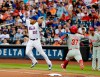 FILE - In this July 11, 2018, file photo, Philadelphia Phillies' Odubel Herrera (37) beats the throw to first base as New York Mets first baseman Dominic Smith (22) leaps to catch the ball during the fourth inning of a baseball game in New York. Smith, 23, was the 11th overall pick in the 2013 draft, and through it all ‚Äì from weight issues to low power numbers in the minors to being tardy in spring camp to battling sleep apnea ‚Äì he appears to have overcome it all and is showcasing the skill set the Mets have been sorely awaiting. (AP Photo/Frank Franklin II, File)