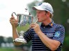 FILE - In this Aug. 19, 2018, file photo, Brandt Snedeker kisses the trophy after winning the Wyndham Championship golf tournament at Sedgefield Country Club in Greensboro, N.C. The PGA Tour’s final regular-season event begins Thursday, Aug. 1, 2019, and as usual there once again will be plenty of bubble players trying to force their way into the top 125 and earn a spot in the first FedEx Cup playoff tournament. But for the first time, there’s some added incentive for those near the top of the points list: The Wyndham Rewards Top 10 program pays out $10 million in bonuses to the top 10 players in the regular season. “It's obviously a huge week for everybody in the field,” defending Wyndham champion Brandt Snedeker said. (AP Photo/Chuck Burton, File)