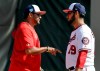 FILE - In this Feb. 16, 2019, file photo, Washington Nationals manager Dave Martinez, left, talks with pitcher Anibal Sanchez during spring training baseball practice, in West Palm Beach, Fla. Dave Martinez heads into Year 2 on the job knowing that his team needs to play better, and win more, than it did in his first season. He began the process of trying to improve by meeting individually with players late last season. (AP Photo/Jeff Roberson, File)