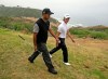 FILE - In this June 9, 2008, file photo, Tiger Woods, left, walks with amateur Jordan Cox along the cliff between the third and fourth holes at Torrey Pines during a practice round for the U.S. Open golf tournament in San Diego. Woods' win 10 years ago is his most recent victory in a major. (AP Photo/Chris Carlson, File)