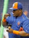 FILE - In this Sept. 5, 2015, file photo, New York Mets third baseman Juan Uribe uses chewing tobacco during batting practice before the Mets played against the Miami Marlins in a baseball game in Miami. Dusty Baker was a big dipper. He's cut back his chaw over the years, but still might pop in a pinch when games get tight.The Washington Nationals manager won't get that choice at some ballparks this season.Big leaguers are now getting a reminder that smokeless tobacco is banned at stadiums in San Francisco, Los Angeles and Boston. (AP Photo/Joe Skipper, File)