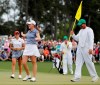 FILE - In this April 6, 2019, file photo, Jennifer Kupcho, second from left, celebrates after sinking a putt on the 18th hole to win the Augusta National Women's Amateur golf tournament in Augusta, Ga. Kupcho advanced to the LPGA Tour finale despite only turning pro five months ago (AP Photo/David Goldman, File)
