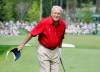 FILE - In this April 9, 2004, file photo, Arnold Palmer bows to the gallery after landing his tee shot only a few feet away from the pin on the sixth green during the second round of the Masters golf tournament at the Augusta National Golf Club in Augusta, Ga. Augusta National has rules, just like most private clubs, and its members expect them to be followed. Unlike other clubs, however, Augusta doesn't just host a major, it runs the major. The heritage built up over eight decades creates an aura that keeps fans and players on their best behavior. (AP Photo/Amy Sancetta, File)