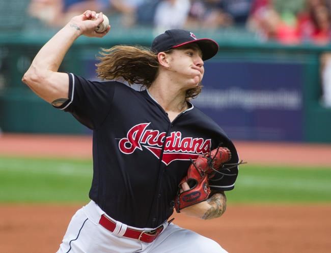 FILE - In this Aug. 30, 2018, file photo, Cleveland Indians starting pitcher Mike Clevinger delivers to the Minnesota Twins during the first inning of a baseball game in Cleveland. Mike Clevinger’s comeback is speeding along like one of his fastball. Cleveland’s starting pitcher has made startling progress from an upper back strain that threatened his season and was expected to sideline him for several months. However, the right-hander, who wasn’t expected to be able to pick up a ball for two months, will throw his second bullpen session on Friday, May 17, 2019. (AP Photo/Phil Long, File)