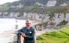 FILE - In this Tuesday, Oct. 20, 2015, file photo, Northern Ireland golfer and former Open golf winner Darren Clarke poses at Royal Portrush, Northern Ireland. His British Open title was part of the groundswell of support that led Royal Portrush to getting the British Open for the first time since 1951. (AP Photo/Peter Morrison, File)