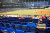 FILE - In this Monday, Aug. 26, 2019 file photo, Fans watch play among empty seats during the second inning of a baseball game between the Miami Marlins and the Cincinnati Reds in Miami. Major League Baseball's average attendance dropped 1.7% this year for its fourth straight decline, and five of the six biggest drops were by teams with losing records. The 30 teams averaged 28,339, according to the commissioner's office, down from 28,830 last year _ the first time the average was below 30,000 since 2003. (AP Photo/Wilfredo Lee, File)