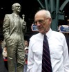 FILE - In this Sept. 15, 2002 file photo, Detroit Tigers Hall of Fame broadcaster Ernie Harwell pauses near a statue honoring him that was unveiled inside the entrance to Comerica Park in Detroit. Their voices are the backdrop to all those warm summer nights. Their distinctive calls are part of the game‚Äôs lore. Fans visualize the action through their stories and descriptions. (AP Photo/Paul Sancya, File)