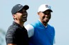 FILE - In this Jan. 26, 2017, file photo, Jason Day, of Australia, left, and Tiger Woods, right, reacts on the fifth hole during the first round of the Farmers Insurance Open golf tournament, at Torrey Pines Golf Course in San Diego. Day won twice this year on the PGA Tour and finished at No. 14, one spot lower than where he started. (AP Photo/Gregory Bull, File)