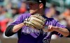 FILE - In this March 18, 2019, file photo, a tattoo of mountains extends down the right arm of left-handed Colorado Rockies starting pitcher Kyle Freeland as he throws against the Cincinnati Reds in a spring training baseball game in Scottsdale, Ariz. Denver native Kyle Freeland wears the affection for his city on his right arm: Tattoos of the area code (303), the elevation (5,280) and a silhouette of the Rocky Mountains. (AP Photo/Elaine Thompson, File)