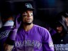FILE - In this June 18, 2018, file photoColorado Rockies' Carlos Gonzalez walks in the dugout after scoring against the New York Mets during the second inning of a baseball game in Denver. A person familiar with the agreement says Gonzalez intends to sign a minor league contract with the Cleveland Indians. Gonzalez, who played the past 10 seasons with Colorado, will sign once he completes a physical and join the Indians at spring training, said the person who spoke Saturday, March 16, to The Associated Press on condition of anonymity because the deal has not been finalized. (AP Photo/Jack Dempsey, File)