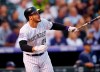 FILE - In this Aug. 21, 2018, file photo, Colorado Rockies' Nolan Arenado watches his RBI-double off San Diego Padres pitcher Robbie Erlin during a baseball game in Denver. Arenado and the Rockies have agreed to a $26 million, one-year deal to avoid arbitration, the largest ever one-year salary for an arbitration-eligible player. Colorado announced the deal Thursday, Jan. 31. (AP Photo/David Zalubowski, File)