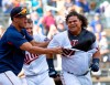 FILE - In this Sept. 9, 2018, file photo, Minnesota Twins' Willians Astudillo, right, is mobbed by teammate Jose Berrios after hitting a 2-run home run during the ninth inning of a baseball game against the Kansas City Royals, in Minneapolis. The most popular player on the first-place Minnesota Twins is the third-string catcher and versatile everyman Willians Astudillo, whose all-out style has endeared him to the team and the fans since his debut last season. His cult hero status reaches a new high on Friday night, when the Twins give away ‚ÄúLa Tortuga‚Äù T-shirts in honor of his nickname, which means turtle in Spanish, at their game against Baltimore. (AP Photo/Paul Battaglia, File)