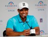 FILE - In this Jan. 24, 2018, file photo, Tiger Woods laughs during a news conference after finishing on the north course at Torrey Pines Golf Course during the pro-am event at the Farmers Insurance Open golf tournament, in San Diego. Woods is starting another year at Torrey Pines, this time with higher expectations. Woods announced Wednesday, Jan. 16, 2019, that he will play in the Farmers Insurance Open next week. (AP Photo/Gregory Bull, File)