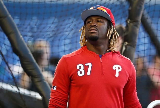 FILE - In this April 12, 2019, file photo, Philadelphia Phillies center fielder Odubel Herrera (37) practices before a baseball game against the Miami Marlins, in Miami. Phillies outfielder Odubel Herrera has been placed on administrative leave by Major League Baseball following his arrest in a domestic violence case at an Atlantic City casino. The commissioner's office put Herrera on leave Tuesday, May 28, 2019, a day after his arrest on an assault charge at the Golden Nugget casino.(AP Photo/Brynn Anderson, File)