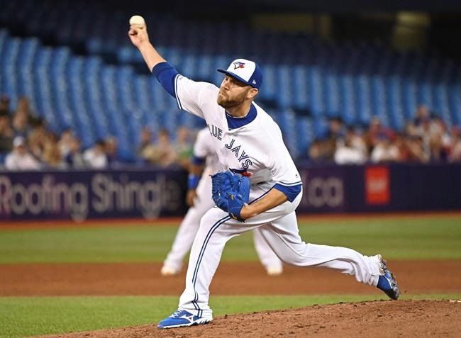 FILE - In this Friday, June 28, 2019 file photo, Toronto Blue Jays' David Phelps pitches against the Kansas City Royals during the sixth inning of a baseball game in Toronto. The Cubs added bullpen depth by acquiring right-hander David Phelps from Toronto for minor league righty Thomas Hatch, Tuesday, July 30, 2019. (Jon Blacker/The Canadian Press via AP, File)