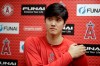 FILE - In this Feb. 13, 2019, file photo, Los Angeles Angels' Shohei Ohtani, recovering from Tommy John surgery, talks to the media at their spring baseball training facility in Tempe, Ariz. Shohei Ohtani, Yu Darvish and Daisuke Matsuzaka are all examples of pitchers who have suffered significant arm injuries relatively early in their major league careers after arriving from Japan. Whether he wants to be or not, Yusei Kikuchi‚Äôs rookie season is a science experiment. An attempt to see whether pitchers brought from Asia to Major League Baseball should be handled differently in their first season. (AP Photo/Chris Carlson, File)