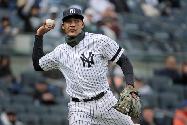 FILE - In this March 31, 2019, file photo, New York Yankees' Miguel Andujar throws to first base during the second inning of the team's baseball game against the Baltimore Orioles at Yankee Stadium in New York. Andújar is set to come off the injured list Saturday, and the team hopes infielder DJ LeMahieu will return to the lineup that day as well. Yankees outfielder Clint Frazier is scheduled to follow on Monday, when center fielder Aaron Hicks could begin a minor league rehab assignment. With 13 players still on the injured list, manager Aaron Boone gave a long rundown of medical status reports Friday, May 3, before New York opened a homestand against the major league-leading Minnesota Twins. (AP Photo/Seth Wenig, File)