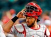 FILE - In this Monday, Aug. 6, 2018 file photo, Philadelphia Phillies catcher Jorge Alfaro (38) watches in the first inning during a baseball game against the Arizona Diamondbacks in Phoenix. During the offseason the Miami Marlins announced new concession offerings that included mushroom tacos, fries with mole sauce and bottomless popcorn and soda. The woebegone franchise‚Äôs biggest offseason move came Thursday, when the Marlins traded All-Star catcher J.T. Realmuto to the Philadelphia Phillies for catcher Jorge Alfaro, two pitching prospects and $250,000 in international signing bonus pool allocation. (AP Photo/Rick Scuteri, File)